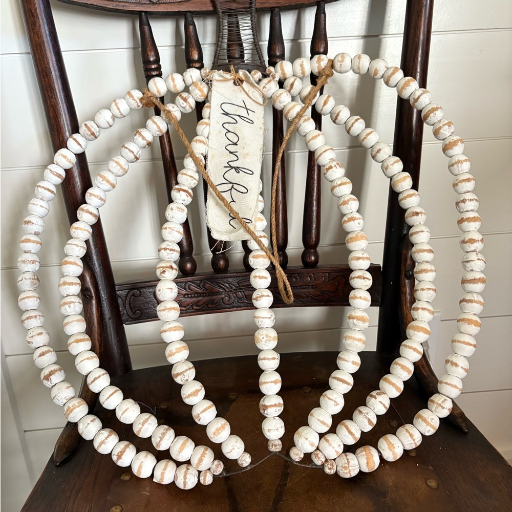 Rustic White Wooden Beaded door hanger in the shape of a pumpkin